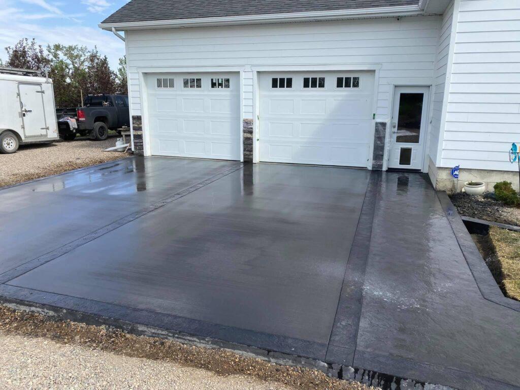 Concrete parking pad with a darker grey shade