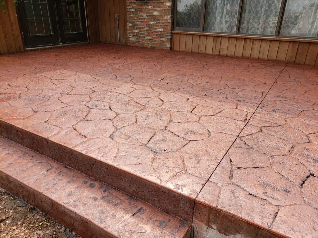 red decorative concrete up to the main doors that looks like older cobblestone