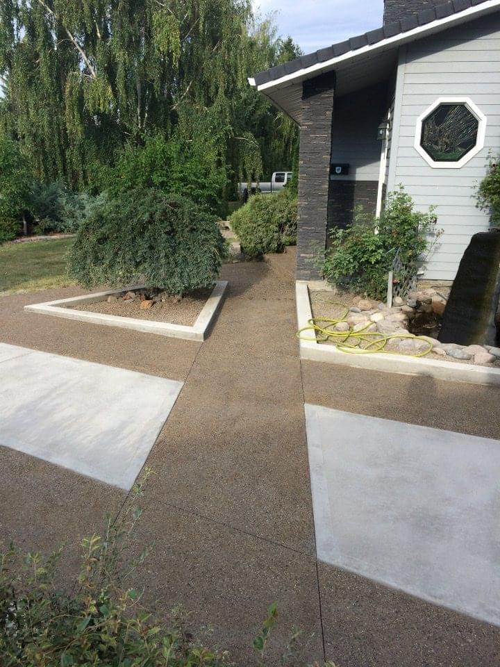 concrete with a tan finished walkway with concrete accents
