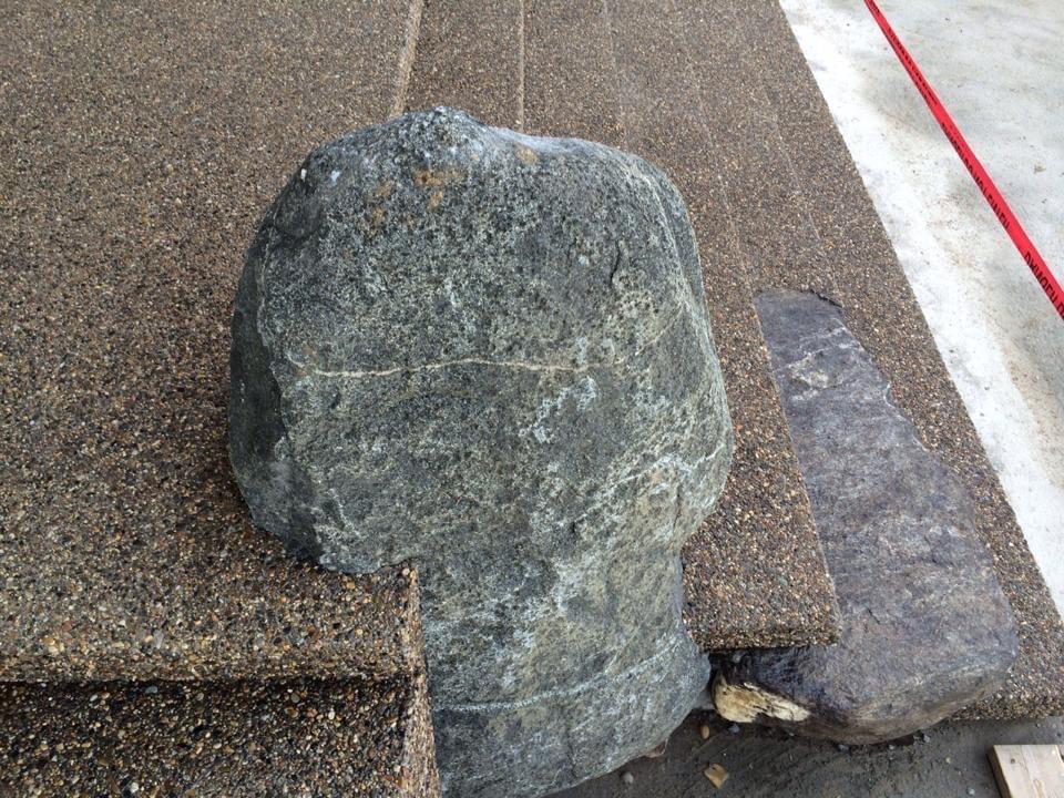 Other side large rock embedded in exposed aggregate concrete