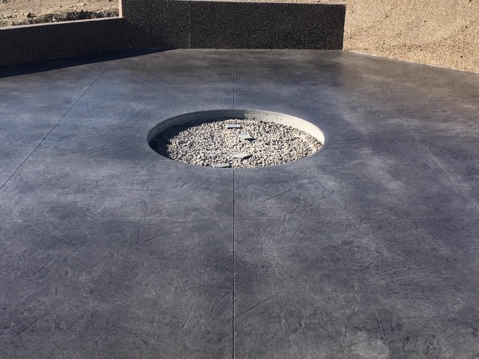 decorative concrete with a circular rock bed in the middle